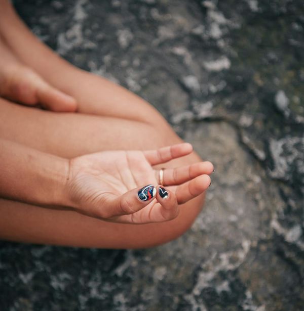 Close up of hands in a meditative mudra position.